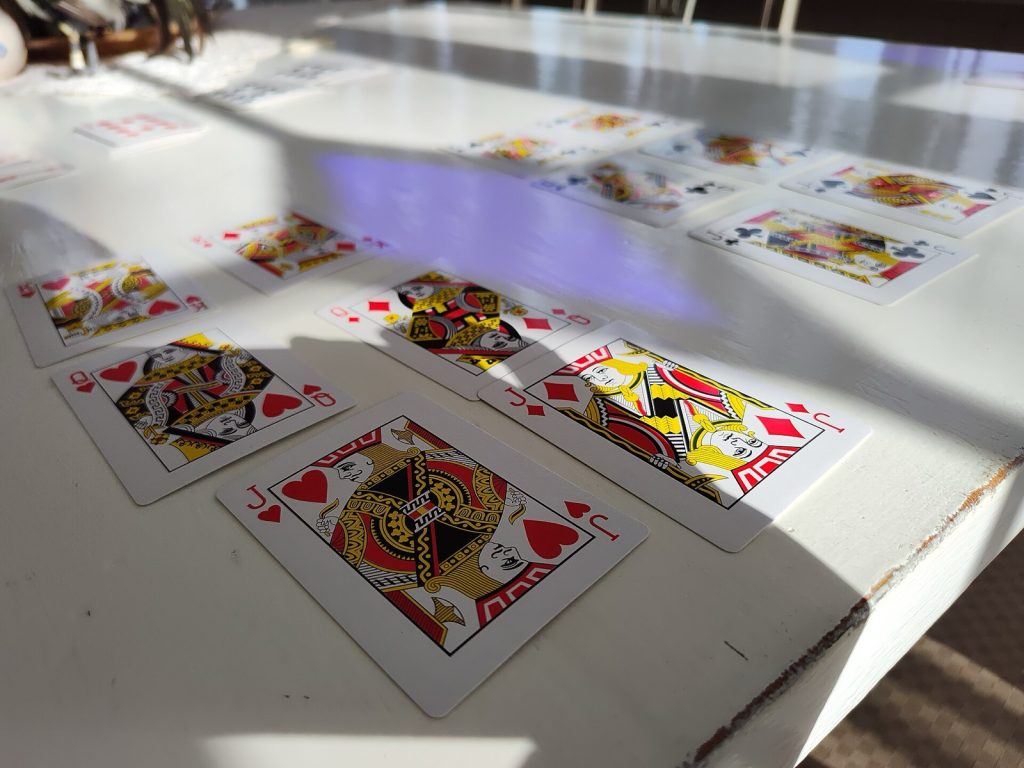 Jacks, queens and kings from a deck of playing cards laid out on a table